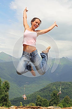 Beautiful joyful woman is jumping. photo