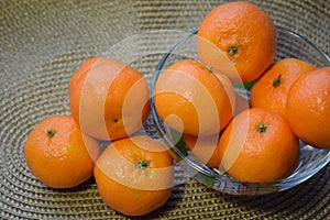 beautiful juicy mandarins in a vase on a table