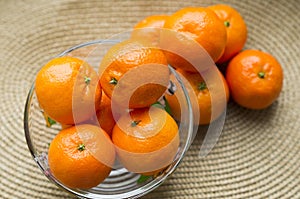 beautiful juicy mandarins in a vase on a table