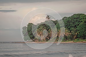 Beautiful jungle caribbean beach with nice surf close to Playa Cocles and Puerto Viejo in Costa rica. View towards the trees. hazy