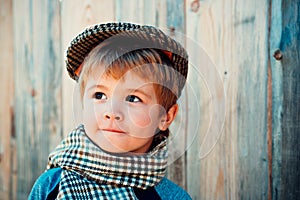 Beautiful kid boy on a wooden background.