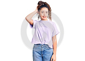 Beautiful kid girl with curly hair wearing casual clothes confuse and wonder about question