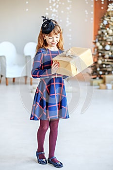 A beautiful kid got a gift box and admired. Concept Happy Chris