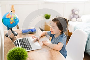 Beautiful kid playing online on the computer