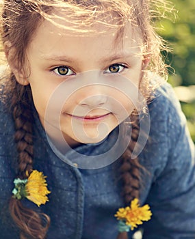 Beautiful kid smiling girl with braided hair style and big cute