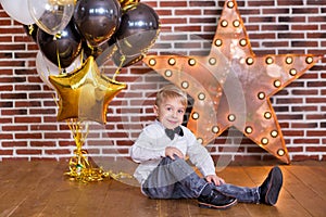 Beautiful kids, little boys celebrating birthday and blowing candles on homemade baked cake, indoor. Birthday party for