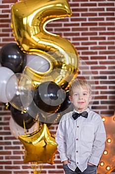 Beautiful kids, little boys celebrating birthday and blowing candles on homemade baked cake, indoor. Birthday party for