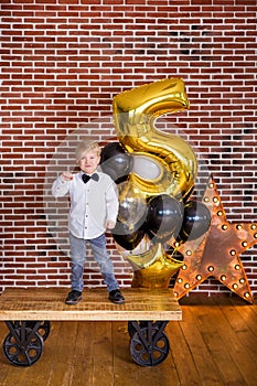 Beautiful kids, little boys celebrating birthday and blowing candles on homemade baked cake, indoor. Birthday party for