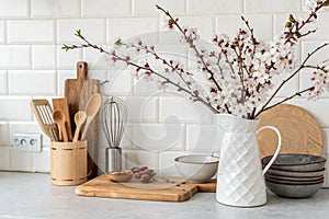 Beautiful kitchen backdrop with utensils and flowering jug