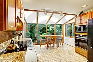 Beautiful kitchen interior. Dining area with transparant glass w