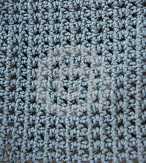 Beautiful knitted grey fabric as background. Needlework as background