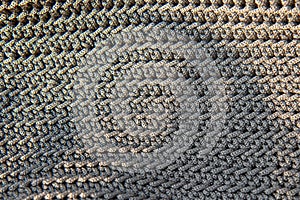 Beautiful knitted grey fabric as background. Needlework as background