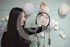 Beautiful Korean the girl holding a dream catcher.