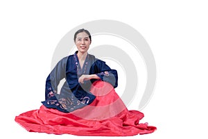 Beautiful Korean girl wearing traditional hanbok Sitting and posing for the photographer to take photos on a white background