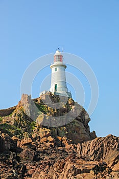 Beautiful La Corbiere lighthouse perched on the rocks in Jersey UK