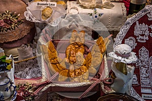 Beautiful lace articles with waster bunny bread on display at a shop window in Bruges, Belgium, Europe
