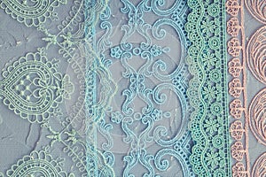 Beautiful laces on a shabby background, a textile product with an ornamental design, light transparent mesh patterned fabric