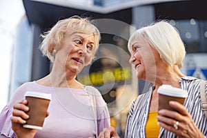 Beautiful ladies having their coffee during the stroll