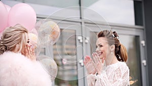 Beautiful ladies in pink and white clothes ready for party.