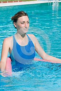 Beautiful lady with aqua tube in swimming pool