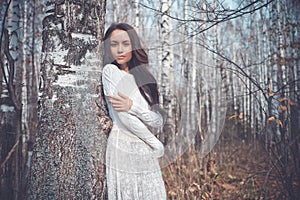 Beautiful lady in a birch forest