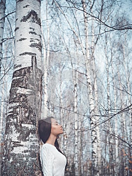 Beautiful lady in a birch forest