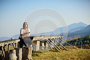 Beautiful lady drinking coffee. Mountain view