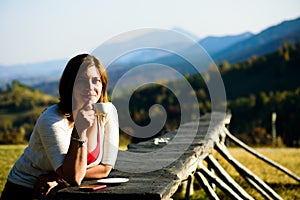 Beautiful lady drinking coffee. Mountain view