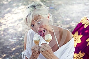 Beautiful lady eating ice cream sitting on a deckchair