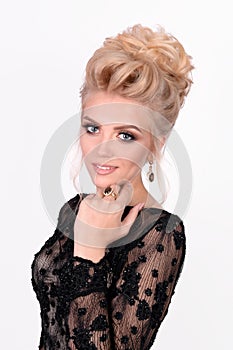 Beautiful lady in elegant black evening dress with updo hairstyle. Fashion photo.