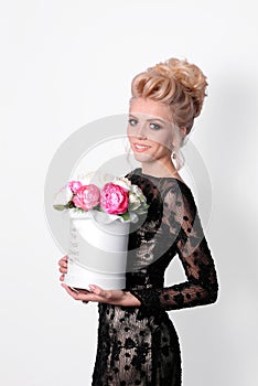 Beautiful lady in elegant black evening dress with updo hairstyle. Fashion photo.