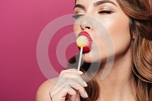 Beautiful lady enjoy and lick lollipop isolated