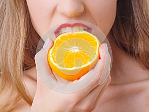 Beautiful lady with fruit posing on camera. Food concept.