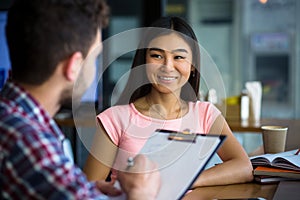 Beautiful lady having interview in restaurant