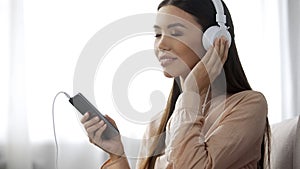 Beautiful lady listening music in headphones, loves radio station, enjoyment