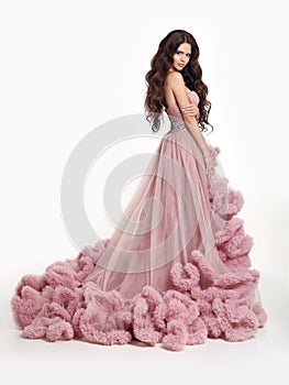 Beautiful Lady in luxury lush pink dress. Fashion brunette woman