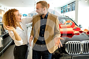 Beautiful lady make surprise to husband in dealership photo