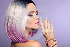 Beautiful lady presents amethyst ring and bracelet jewelry set. Woman portrait with ombre bob short hairstyle and manicured nails