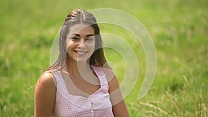 Beautiful lady sit on grass in field