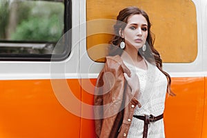 Beautiful lady standing near retro car.