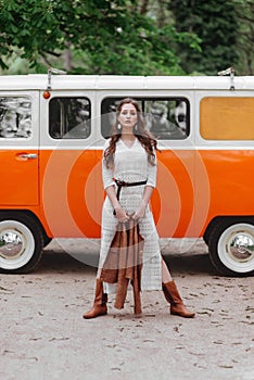 Beautiful lady standing near retro car.