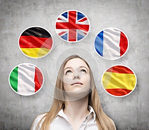 Beautiful lady is surrounded by bubbles with european countries' flags (Italian, German, Great Britain, French, Spanish).
