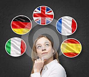 Beautiful lady is surrounded by bubbles with european countries' flags (Italian, German, Great Britain, French, Spanish). Learning