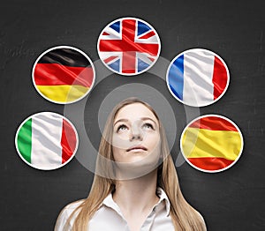 Beautiful lady is surrounded by bubbles with european countries' flags (Italian, German, Great Britain, French, Spanish). Learning