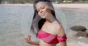 Beautiful lady tourist in bikini resting at seashore