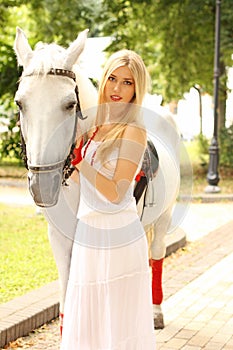 Beautiful lady with white horse