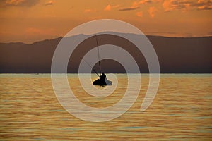 beautiful lake Baikal, a boat with fishermen at sunset