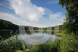 A beautiful lake in the forest. blue sky with clouds