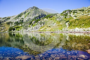 Beautiful lake with mountain reflection in Retezat