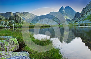 Beautiful lake with mountain reflection in Retezat, Romania